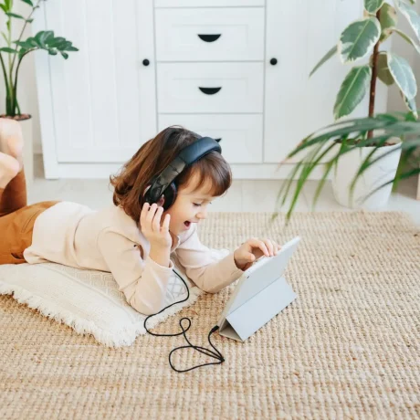 little-girl-with-headphones-using-digital-tablet-d-2024-10-14-18-18-16-utc