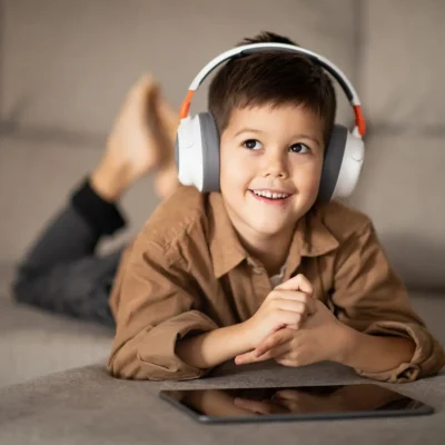 thoughtful-happy-small-european-boy-in-headphones-2023-11-27-05-22-10-utc