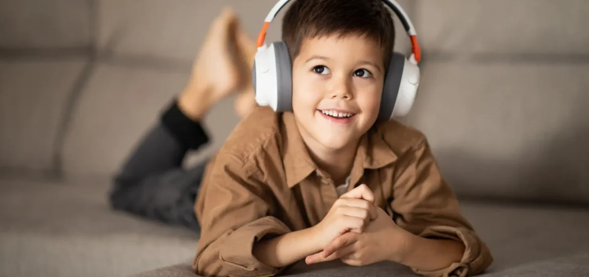 thoughtful-happy-small-european-boy-in-headphones-2023-11-27-05-22-10-utc